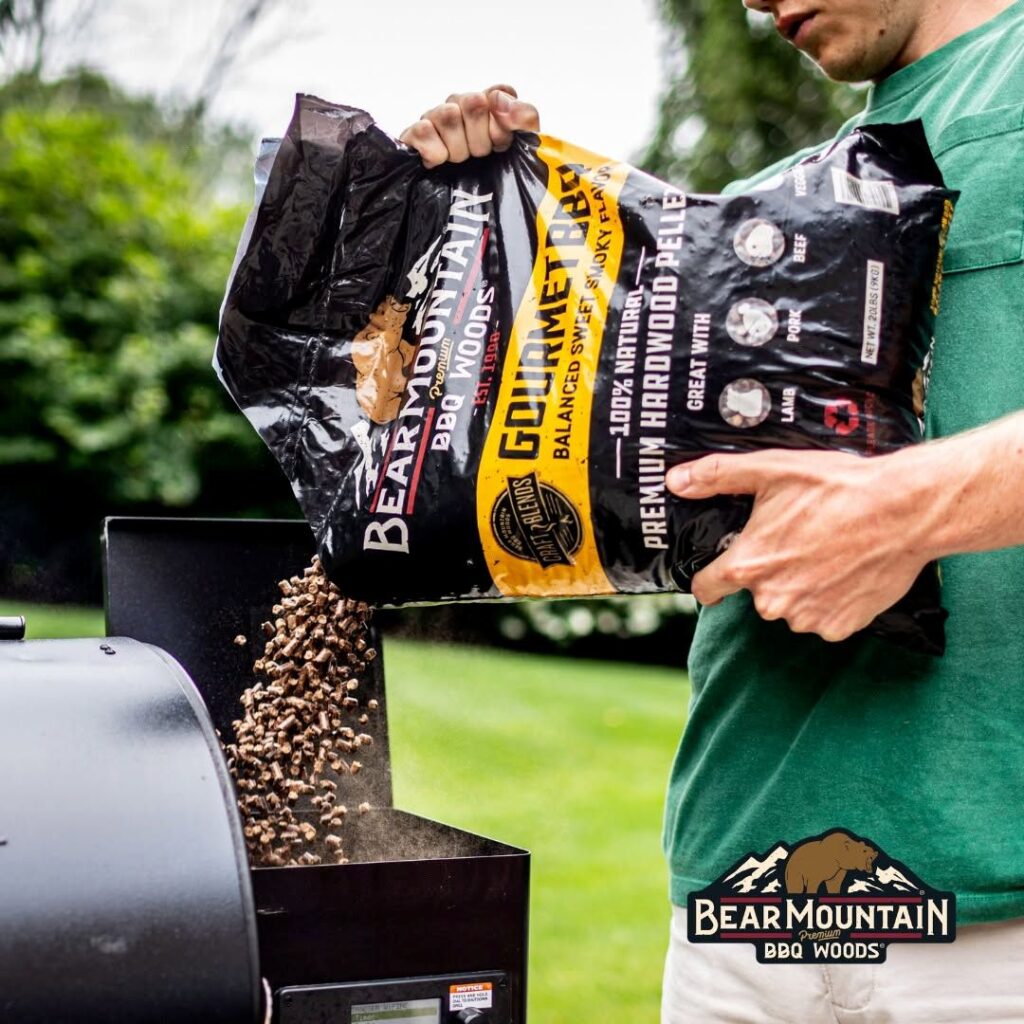 Bear Mountain BBQ pellets being poured into a pellet smoker